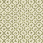 Patterned cotton fabric with green leaf trellis on a beige background