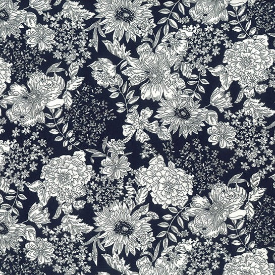 Toile floral print of black and white flowers on a dark navy background.  Perfect smooth weight of 100% cotton for dressmaking or craft projects. Available to buy in half metre increments at Fabric Focus Edinburgh.
