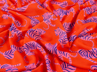 Gorgeous viscose lawn of pink tigers on an orange background from Fabric Godmother and available at Fabric Focus Edinburgh.