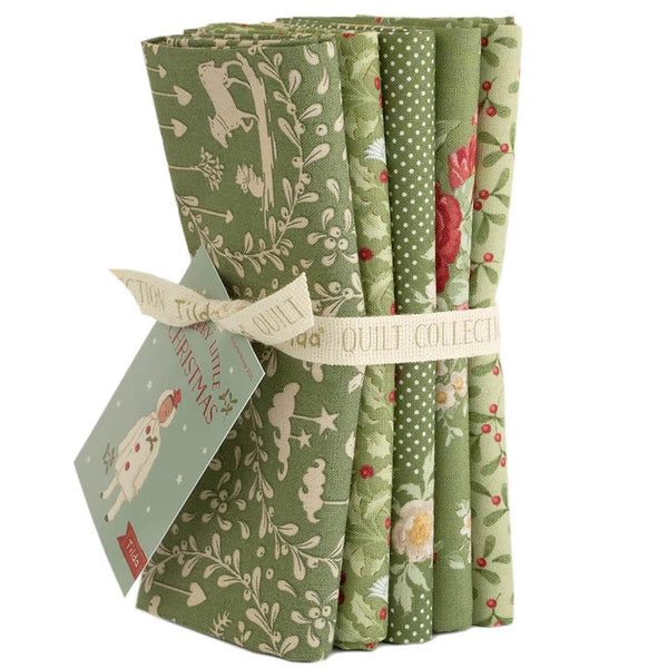 Set of green fabric rolls with various patterns and a card on a white background
