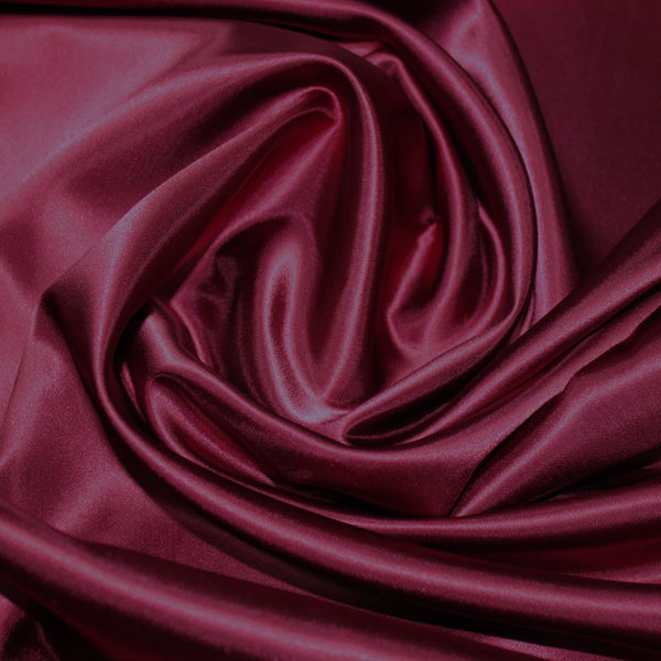 A great satin for evening wear or as a luxurious lining to a coat or jacket. Comes in various beautiful shades. This being the rich Wine. Dry Clean Only NOTE - This fabric will mark if in contact with water Use a dry iron when pressing Available to buy online in half metre increments at Fabric Focus Edinburgh.