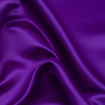 Duchess Satin fabric is a highly lustrous, smooth, very finely woven heavy non stretch satin. It has a very subtle sheen that is classic and elegant and very different in appearance to most satins which generally have a high gloss finish. This is the bold Violet. Sold in half meter lengths at Fabric Focus.
