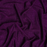 'Dazzle' Jersey is a soft handle, slinky jersey, perfect for dresses skirts and tops. Covered in a fine glitter! Stunning and easy to sew. This being the rich jewel tone Plum. Available to buy in half metre increments.