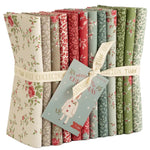 Collection of floral fabric bundles with a ribbon and Christmas-themed card on a white background