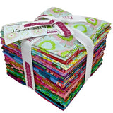 Stack of colorful fabric squares tied with a white ribbon on a white background