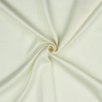 A beautiful soft polyester satin that has a subtle sateen sheen rather than a high gloss finish usually associated with satins. Because of this it has a high-end expensive look. Perfect for evening wear and day wear alike! This being the classic ecru colourway.  Sold in half meter lengths at Fabric Focus.