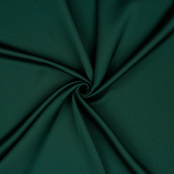 A beautiful soft polyester satin that has a subtle sateen sheen rather than a high gloss finish usually associated with satins. Because of this it has a high-end expensive look. Perfect for evening wear and day wear alike! This being the rich forest green colourway.  Sold in half meter lengths at Fabric Focus.