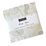 Fabric swatch with leaf pattern and Moda label on a white background