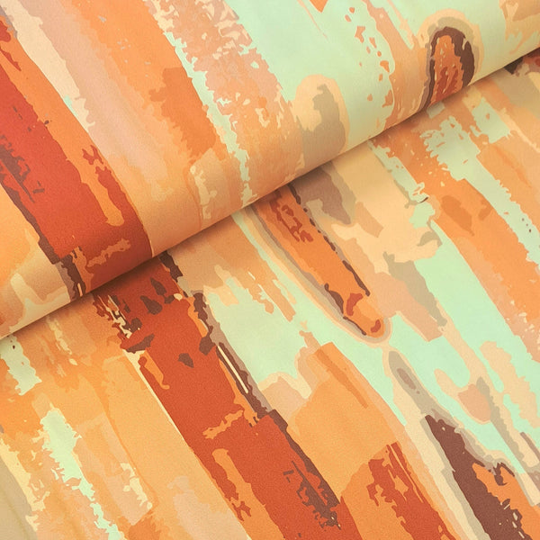 Gorgeous viscose twill of shades of coral in a brush stroke design on a cream background and available at Fabric Focus Edinburgh