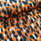 portia polyester jersey.5054. orange. Fabric Focus