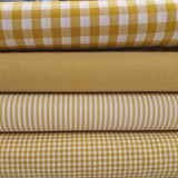 yarn dyed cotton. ochre. strip, plain gingham. Fabric Focus