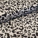 Stunning print of black leopard spots on a white background. A cotton and elastane base. Sold online and in store at Fabric focus Edinburgh.