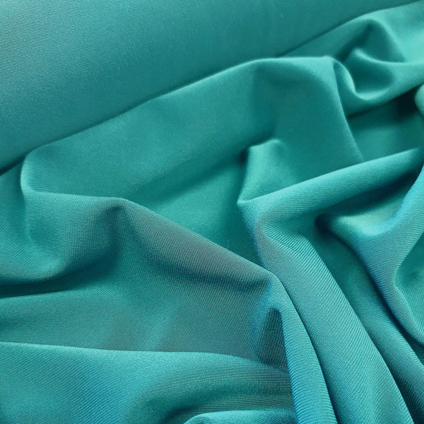'Affable' polyester elastane jersey in a beautiful dark teal colour way. Available to buy in store and online at Fabric Focus Edinburgh.