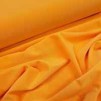 'Affable' polyester elastane jersey in a rich mango colour way. Available to buy in store and online at Fabric Focus Edinburgh.