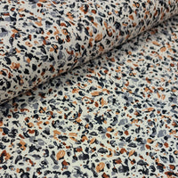 ditzy viscose print of brown, grey, black and mustard on a stone cream background.