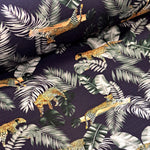 This fabric is a stretchy jersey knit of the most beautiful quality. A wonderful jungle print jersey with leopards on a dark navy background. Great for tops and dresses. Available to buy in half metre increments.
