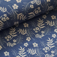 Light weight cotton chambray with a white line design in a scattered tropical floral motif. Classic White on a denim/sky colour way for that nautical look, ideal for summer shirts, tops and dresses. Perfect holiday classic. Sold in half metre increments at Fabric Focus.