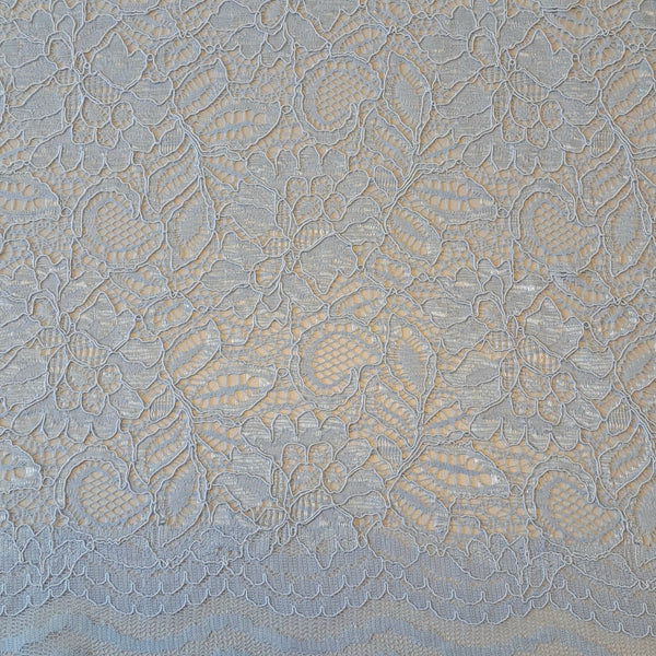 Tocca Lace  is an exquisite corded lace fabric with a pretty scallop along both edges. The colours available in this range are simply stunning and will be perfect to make a statement piece for a wedding, special occasion and evening wear. In the softest icy blue colourway called Illusion Blue. Available to buy in half metre increments.