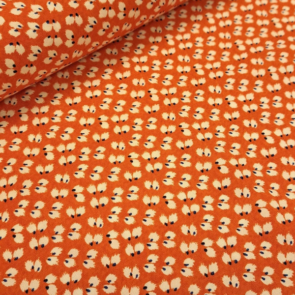poppy red viscose with small ditzy white print. perfect for dresses and blouses. Available in store and on line at Fabric Focus