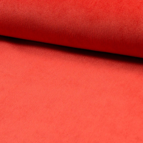 A stretch polyester corduroy in Bright Orange. Available to buy in store and online at Fabric Focus Edinburgh.