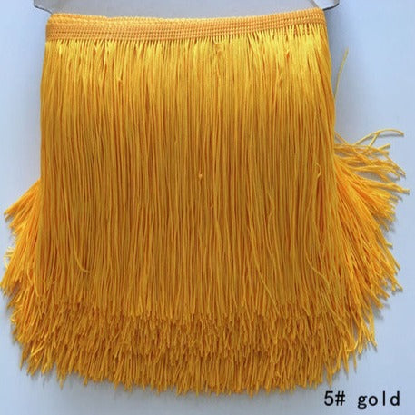 polyester fringing in gold colour way. 15cm drop. Available to buy in store and online at Fabric Focus Edinburgh.