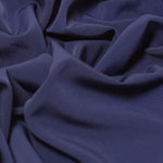 Beautiful self coloured crepe with great drape in a classic navy blue.  Suitable for day and evening wear alike. 100% Polyester. Sold in half meter lengths.