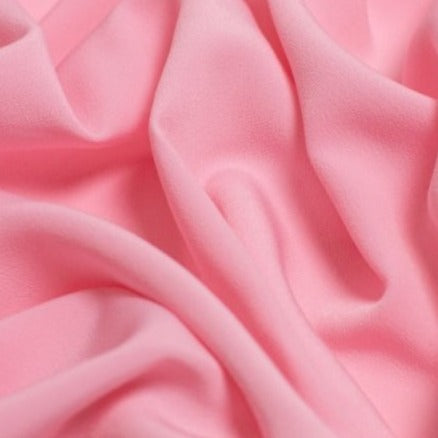 Beautiful self coloured crepe in the chicest Baby Pink, with great drape.  Suitable for day and evening wear alike. 100% Polyester. Sold in half meter lengths at Fabric Focus.