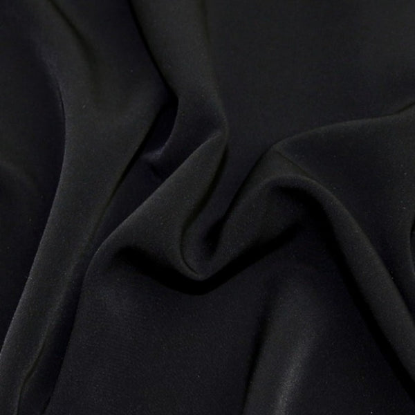 Beautiful self coloured crepe with great drape in classic black.  Suitable for day and evening wear alike. 100% Polyester. Sold in half meter lengths.