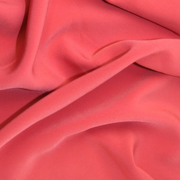 Luxury polyester crepe in coral pink colour way. Available to order in store and online at Fabric Focus Edinburgh.