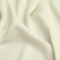 Luxury Crepe in Ivory. 100% Polyester. Available to order online or in store at Fabric Focus Edinburgh.
