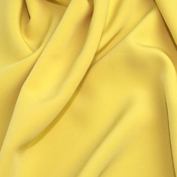 Polyester Luxury crepe in lemon yellow. Available to order online and in store at Fabric Focus Edinburgh.