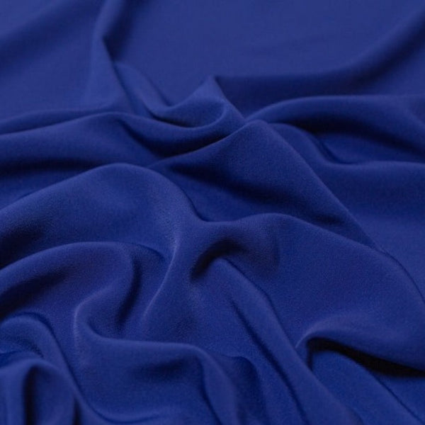 Beautiful self coloured crepe with great drape in a rich royal blue.  Suitable for day and evening wear alike. 100% Polyester. Sold in half meter lengths.