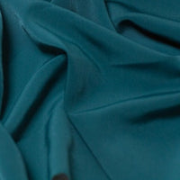 Beautiful self coloured crepe with great drape in classic teal.  Suitable for day and evening wear alike. 100% Polyester. Sold in half meter lengths.