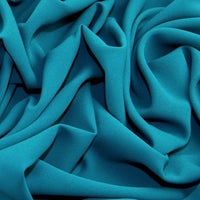 This beautiful crepe lives up to its name - Prestige! A soft handle with beautiful drape.  Available in various shades including this rich teal. It is machine washable at 30 degrees and easy to sew.  Sold in half meter lengths.