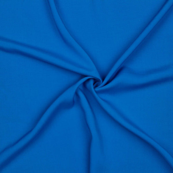 A beautiful plain viscose fabric in a stunning fashionable electric blue colour. perfect for wrap dresses, wide legged trousers and blouses. Mix with printed viscose for a great summer ensemble. Available to buy in half metre increments at Fabric Focus.