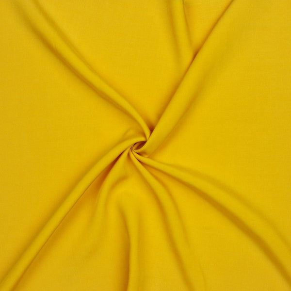 A beautiful plain viscose fabric in a stunning fashionable ochre colour. perfect for wrap dresses, wide legged trousers and blouses. Mix with printed viscose for a great summer ensemble. Available to buy in half metre increments at Fabric Focus.